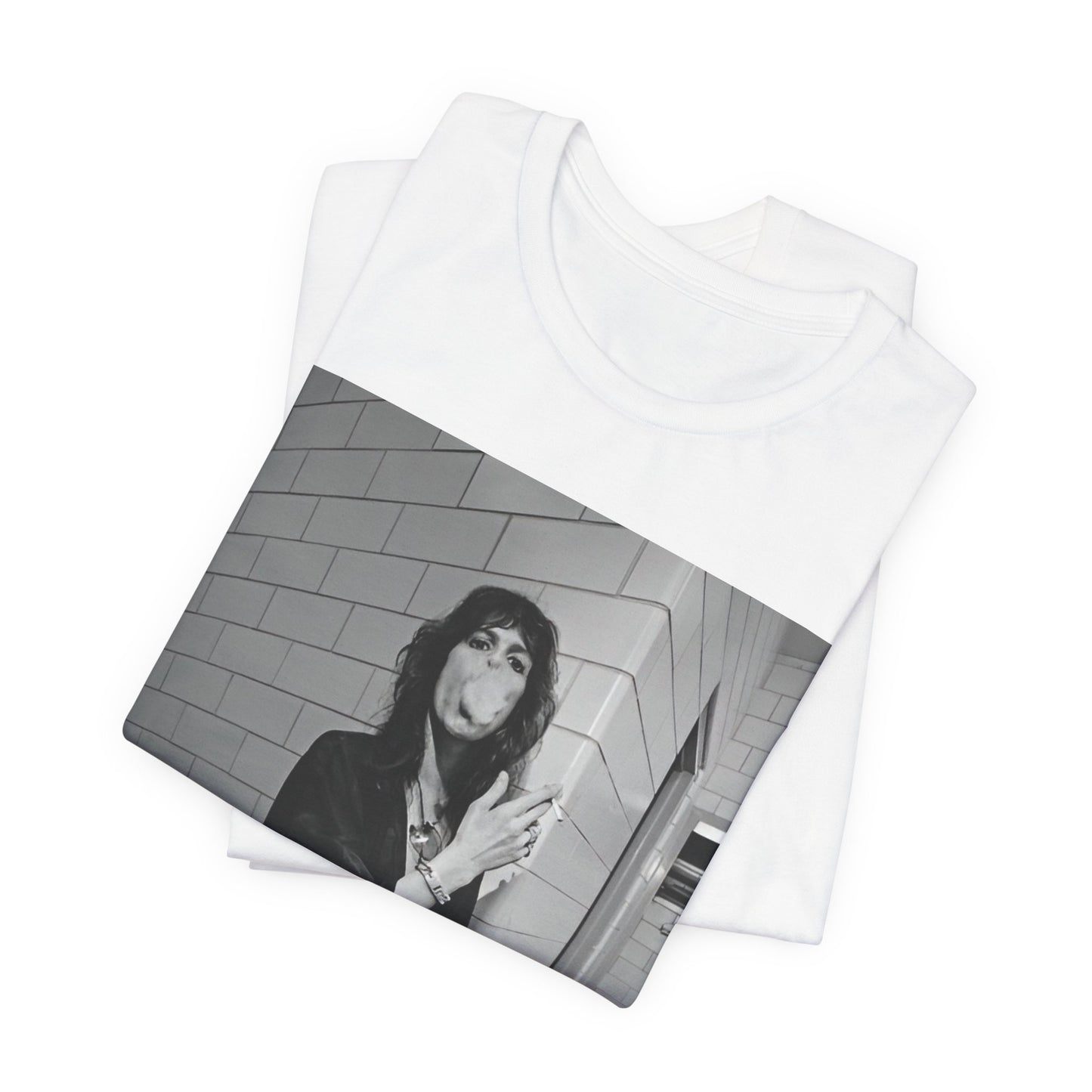 A black graphic t-shirt featuring a retro 70s photo of Aerosmith band members in a backstage setting, showing a candid moment.