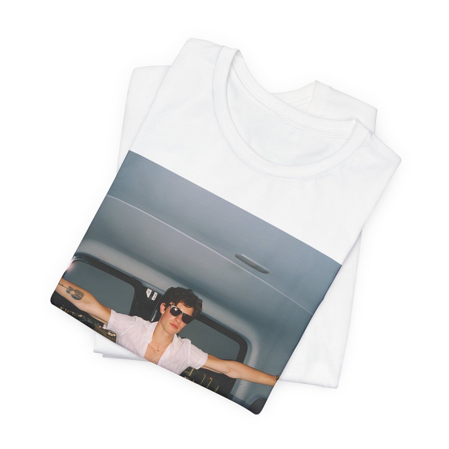 A black graphic t-shirt featuring a graphic of Shawn Mendes with a classic confident look.
