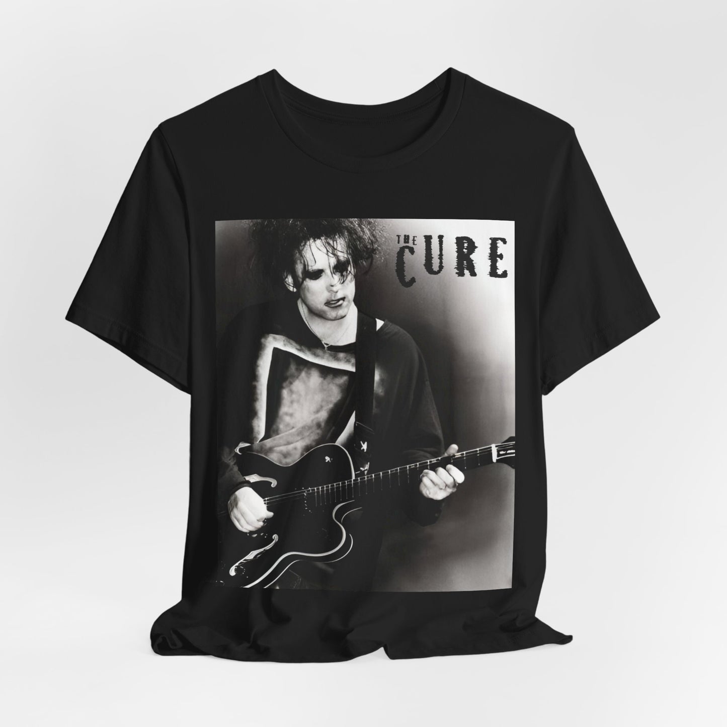 A black graphic t-shirt featuring a vintage goth rock graphic of The Cure.