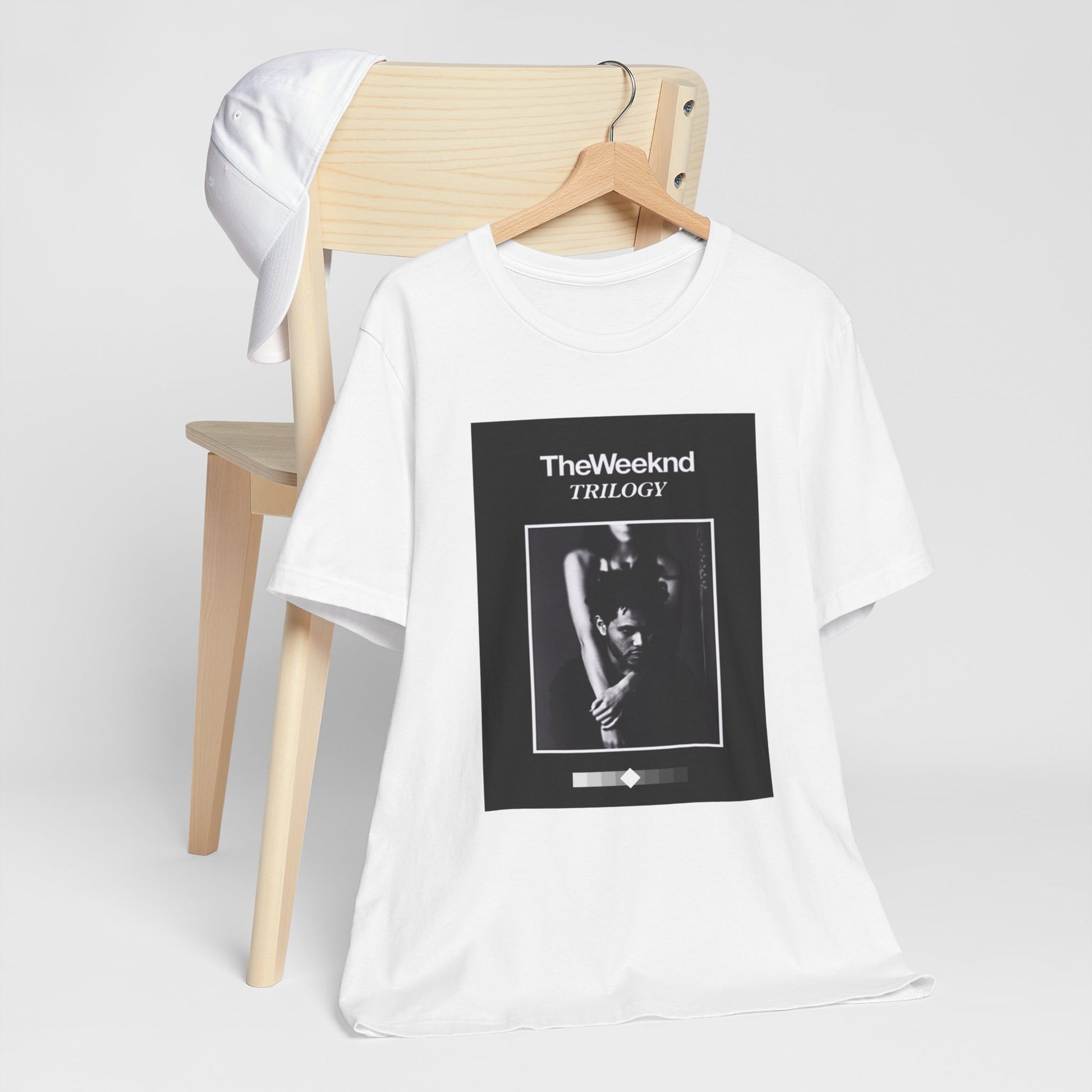 A black graphic t-shirt featuring a graphic related to The Weeknd's 'Trilogy' album.