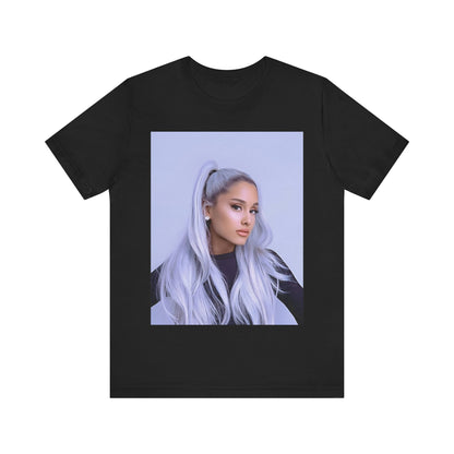 A black graphic t-shirt featuring a stylized graphic of Ariana Grande, possibly with a crown or 'Pop Queen' text, emphasizing her iconic status.