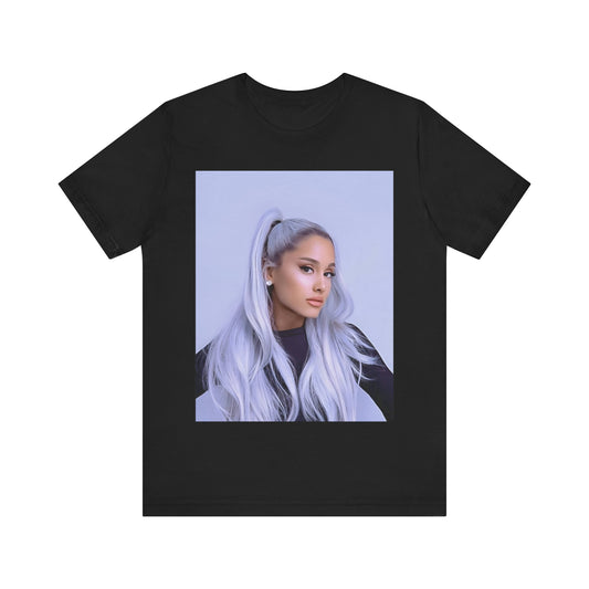 A black graphic t-shirt featuring a stylized graphic of Ariana Grande, possibly with a crown or 'Pop Queen' text, emphasizing her iconic status.