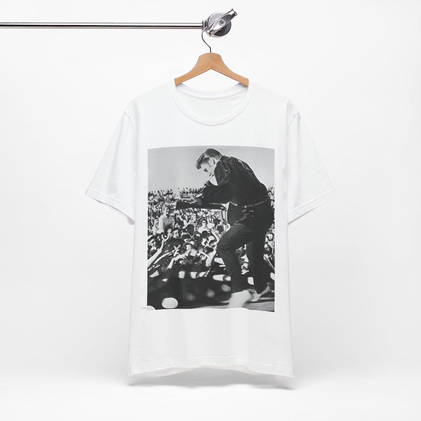 A black graphic t-shirt featuring a retro photo of Elvis Presley performing live in concert in the 1950s.