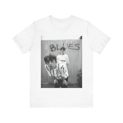 A black graphic t-shirt featuring a graphic of Liam and Noel Gallagher from Oasis, showing their support for Manchester City.
