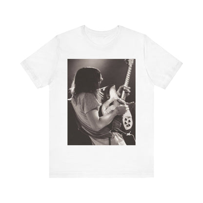 A black graphic t-shirt featuring a black and white graphic or photo of Tame Impala performing live on stage.