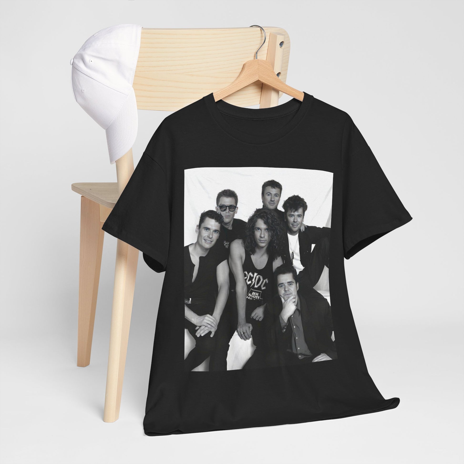 A black graphic t-shirt featuring an 80s rock aesthetic graphic of INXS.