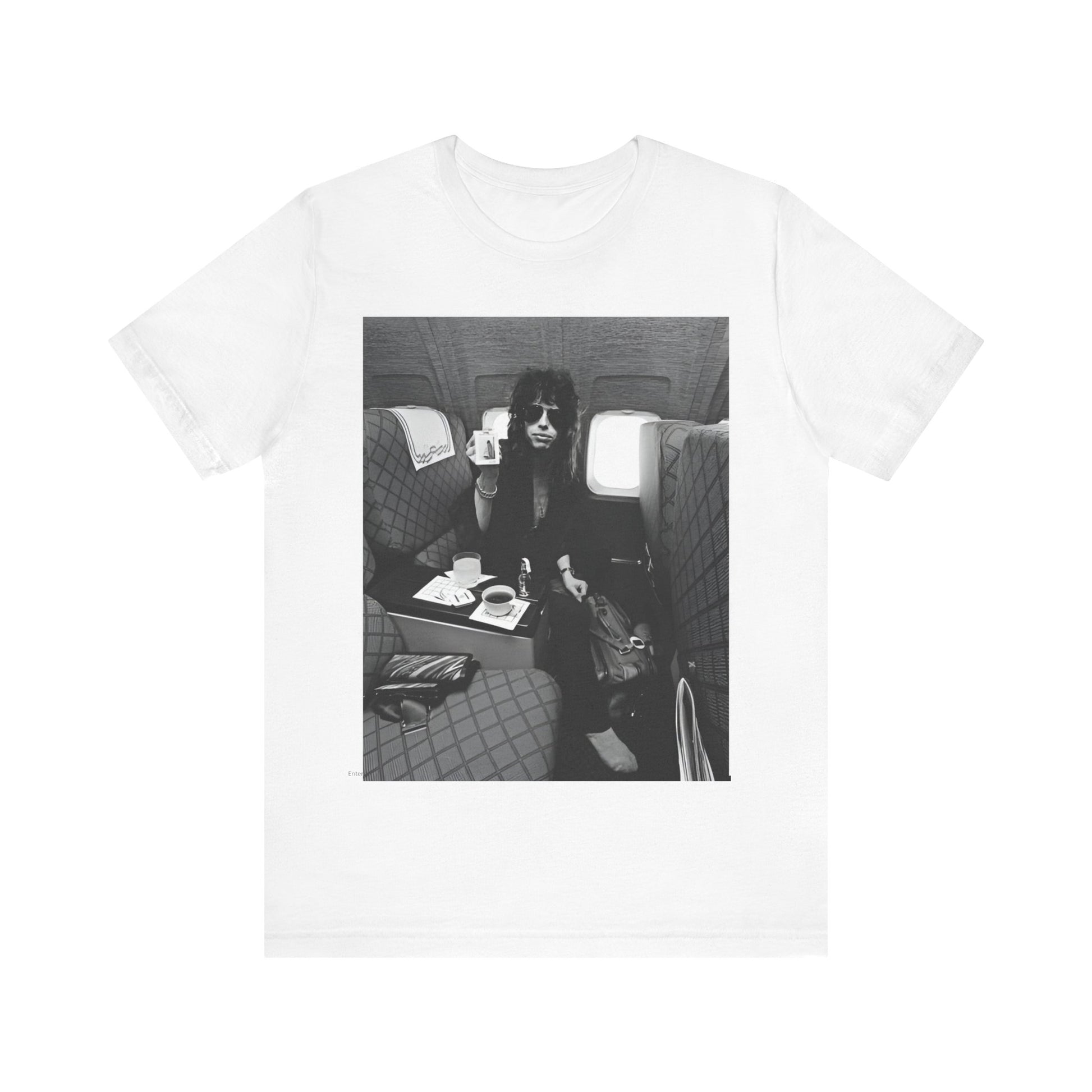 A black graphic t-shirt featuring a vintage 70s-style illustration of an airplane with Aerosmith branding, representing their tour plane from that era.