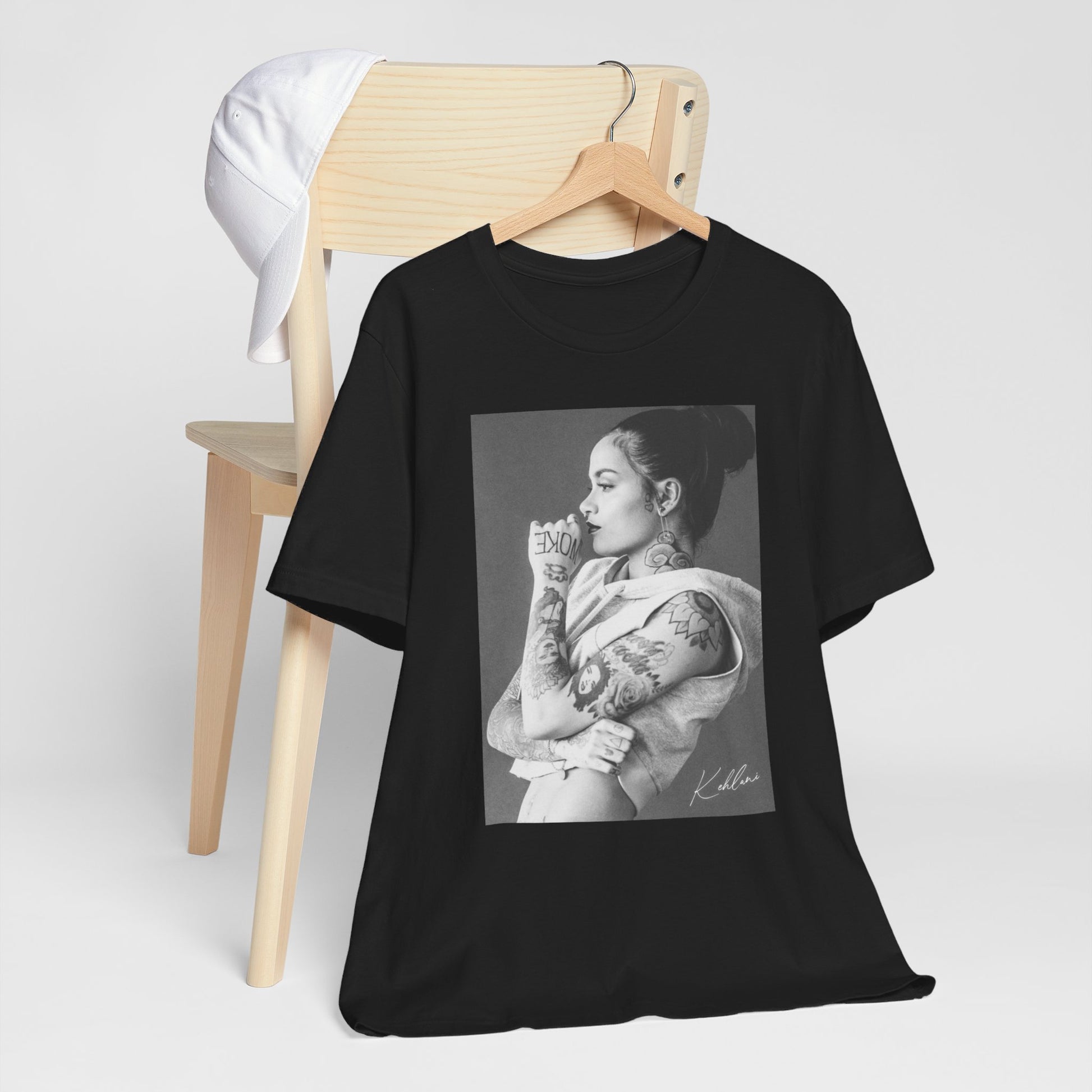 A black graphic t-shirt featuring a black and white, monochrome graphic or photo of Kehlani.
