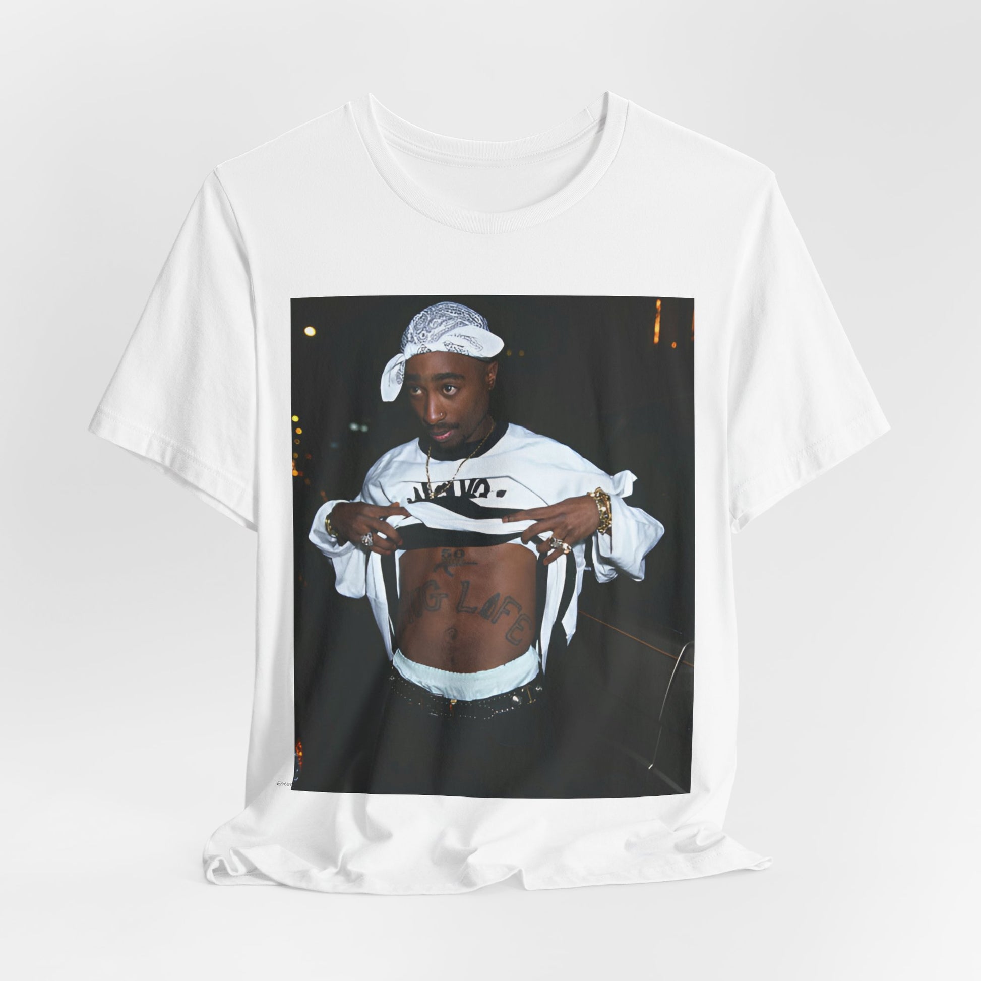A black graphic t-shirt featuring a graphic of Tupac Shakur (2Pac).