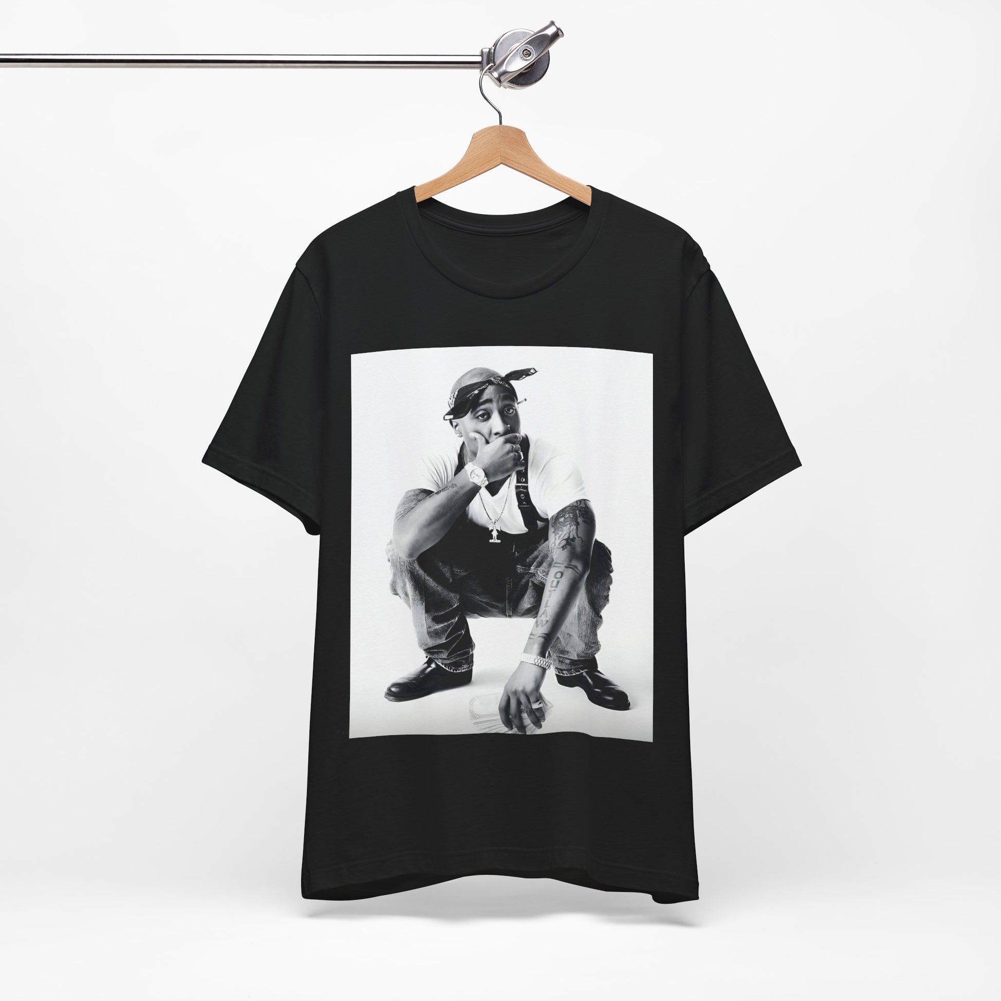 A black graphic t-shirt featuring a graphic of Tupac with a conscious rap vibe.