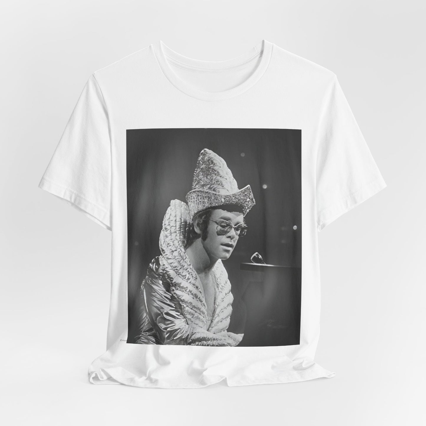 A black graphic t-shirt featuring a 70s pop aesthetic graphic of Elton John.