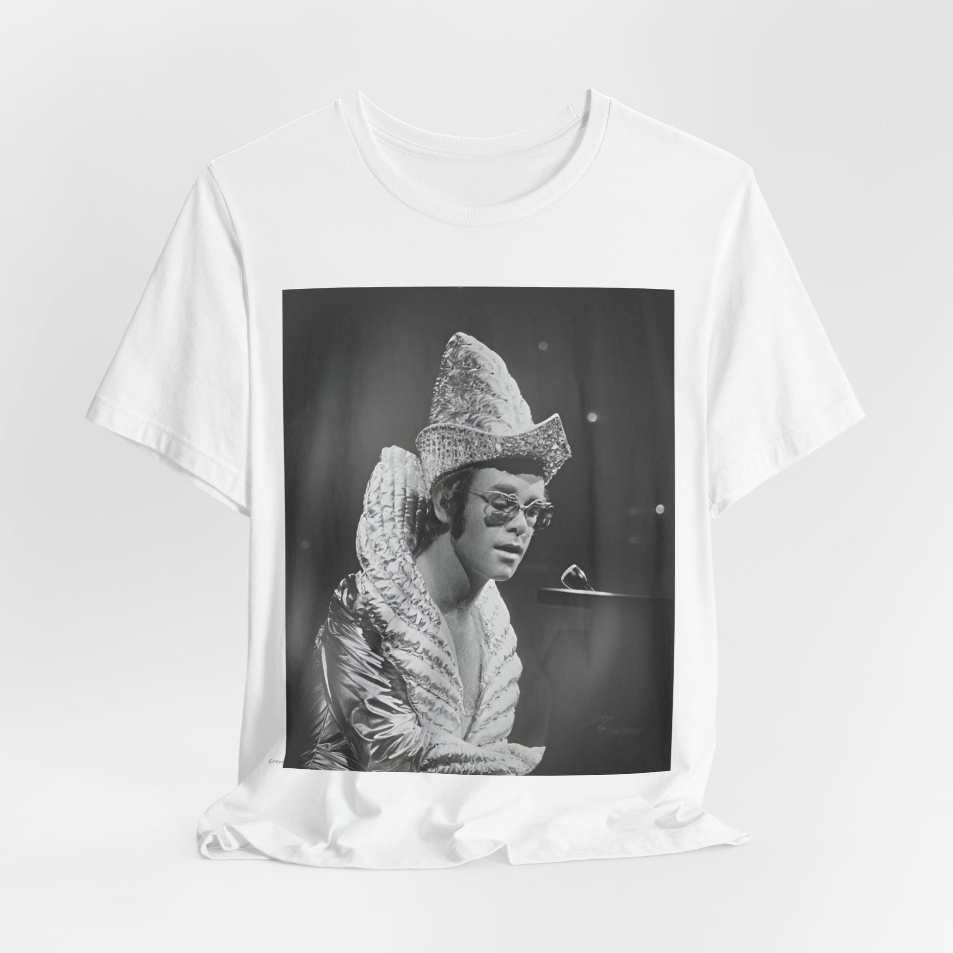 A black graphic t-shirt featuring a 70s pop aesthetic graphic of Elton John.