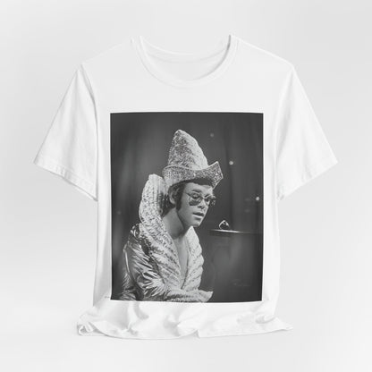 A black graphic t-shirt featuring a 70s pop aesthetic graphic of Elton John.