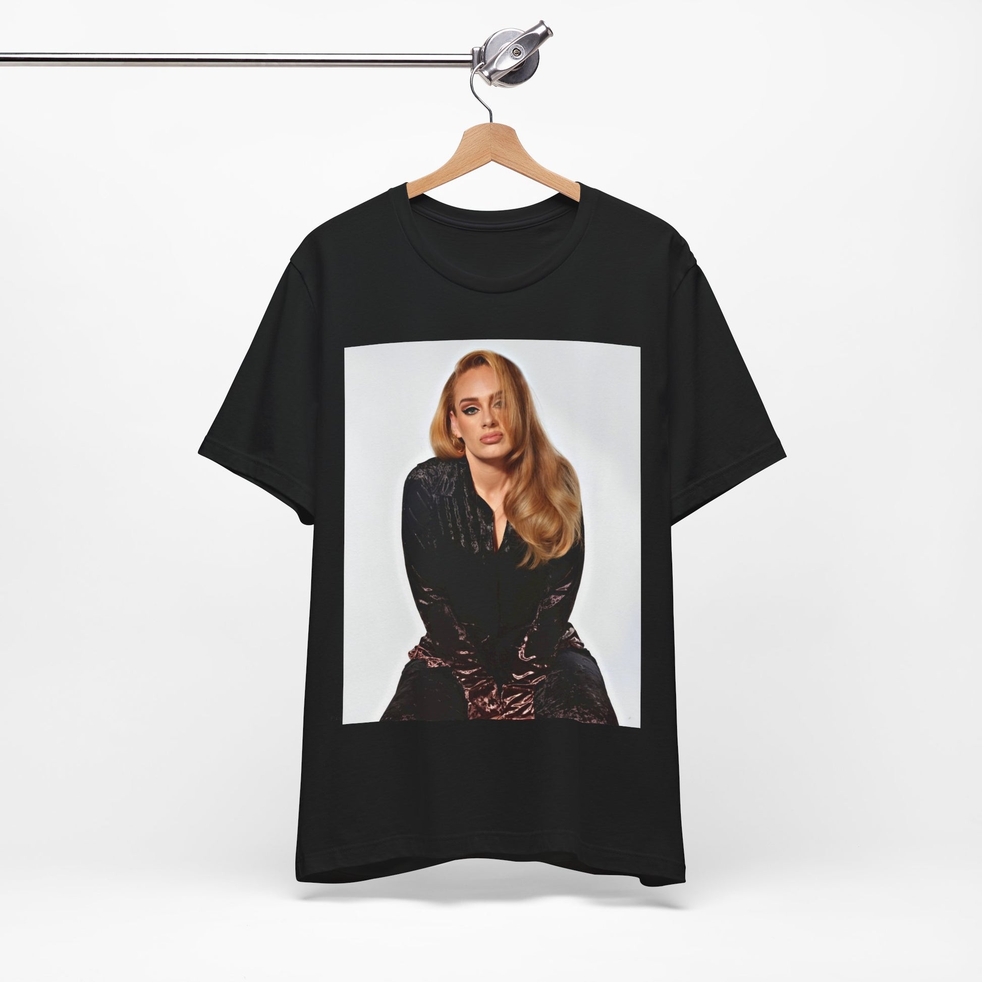 A black graphic t-shirt featuring a portrait of Adele from her iconic blonde era, with her hair styled and her expression poised and elegant.