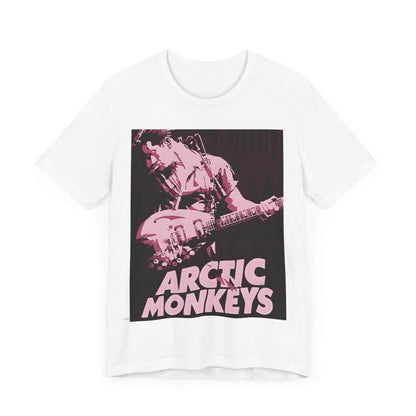 A black graphic t-shirt featuring the Arctic Monkeys logo in a prominent pink color, creating an aesthetic look.