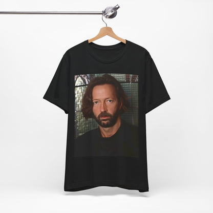 A black graphic t-shirt featuring a portrait graphic of Eric Clapton as a guitar god legend.