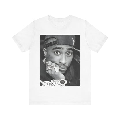 A black graphic t-shirt featuring a bold graphic of Tupac as a rap superstar.