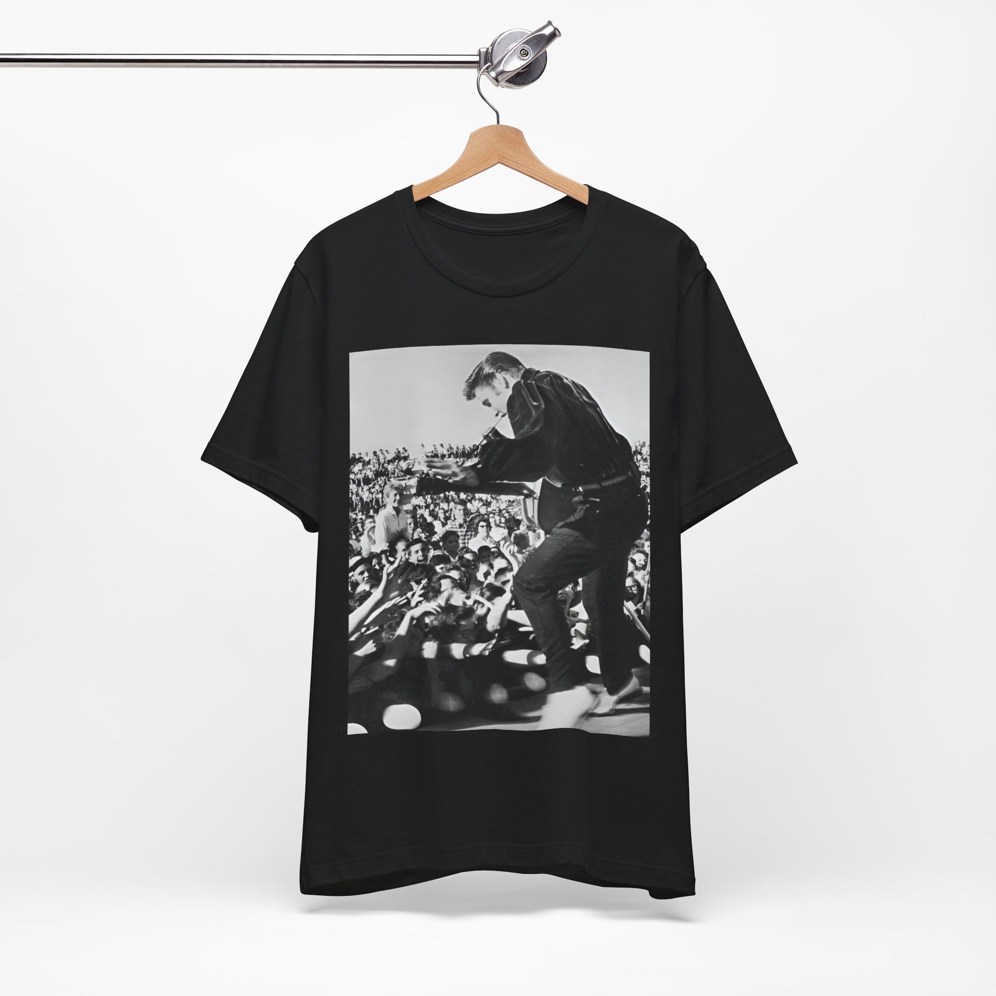 A black graphic t-shirt featuring a retro photo of Elvis Presley performing live in concert in the 1950s.