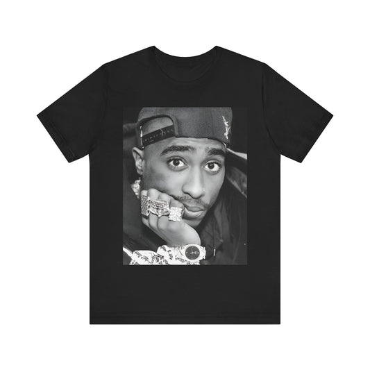 A black graphic t-shirt featuring a bold graphic of Tupac as a rap superstar.