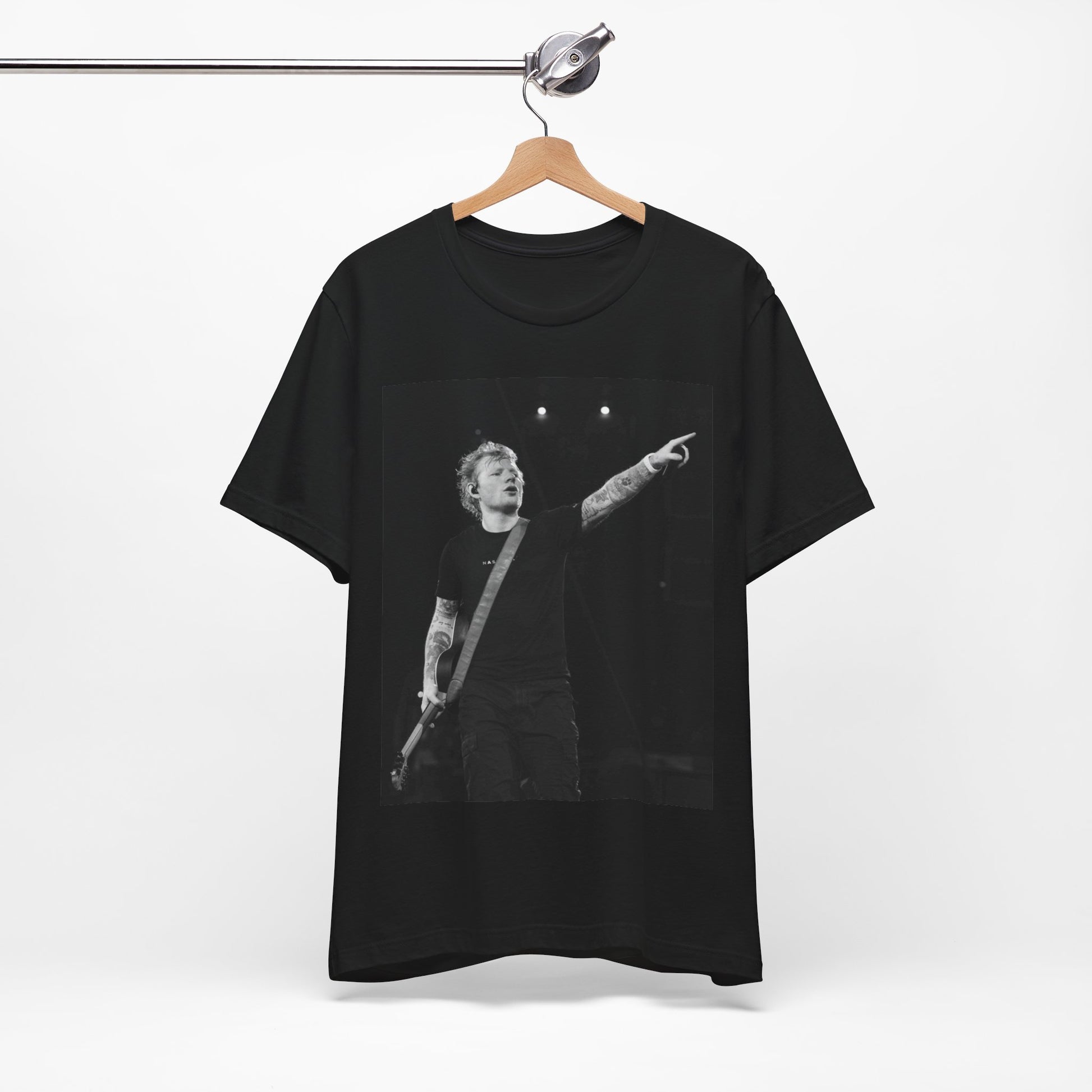 A black graphic t-shirt featuring a black and white graphic or photo of Ed Sheeran performing live on stage.