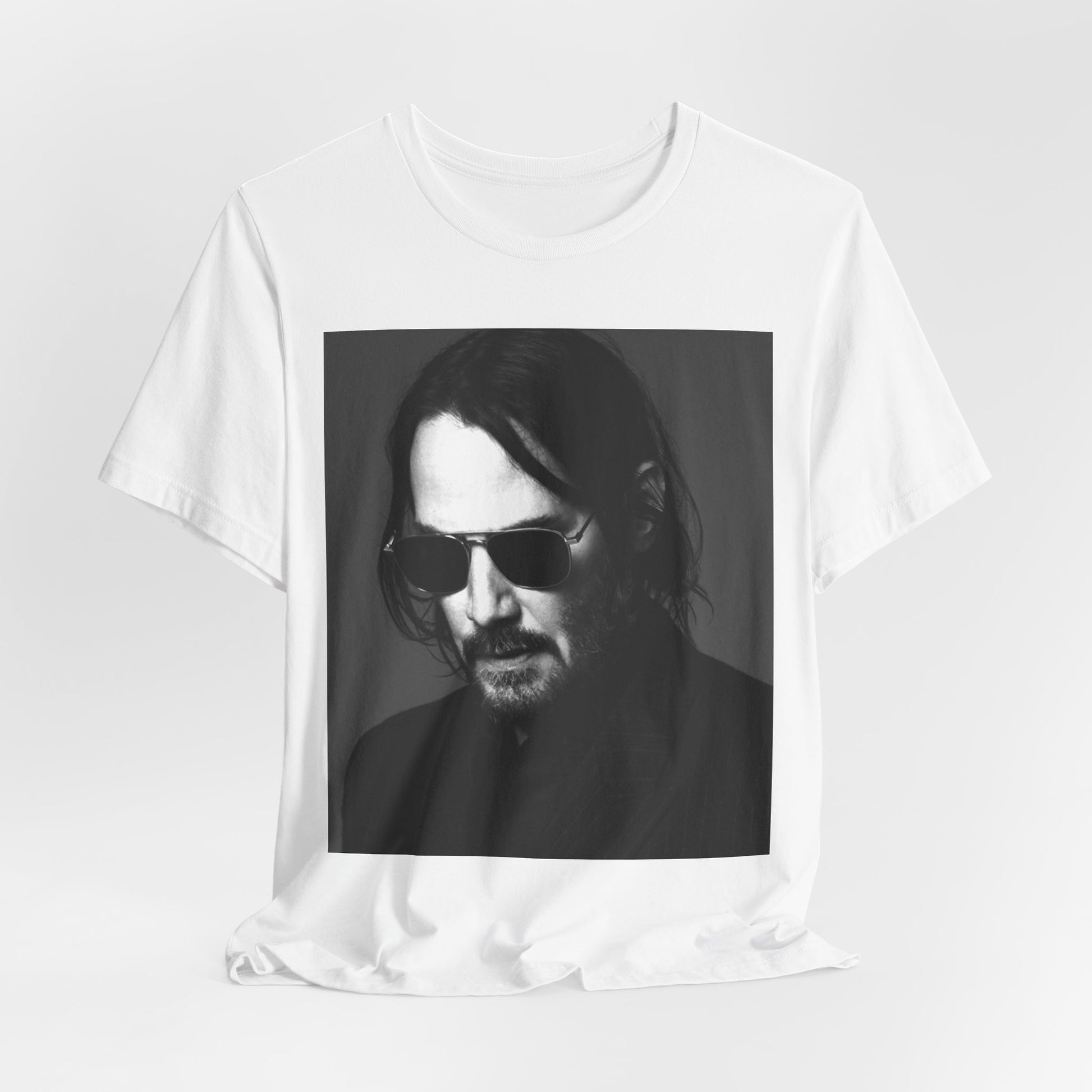 A black graphic t-shirt featuring a graphic of Keanu Reeves with a rebel spirit aesthetic.