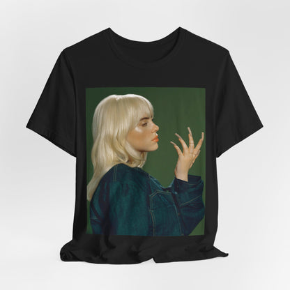 A vintage-style portrait of Billie Eilish with platinum blonde hair and long nails, wearing a denim jacket against a green background.