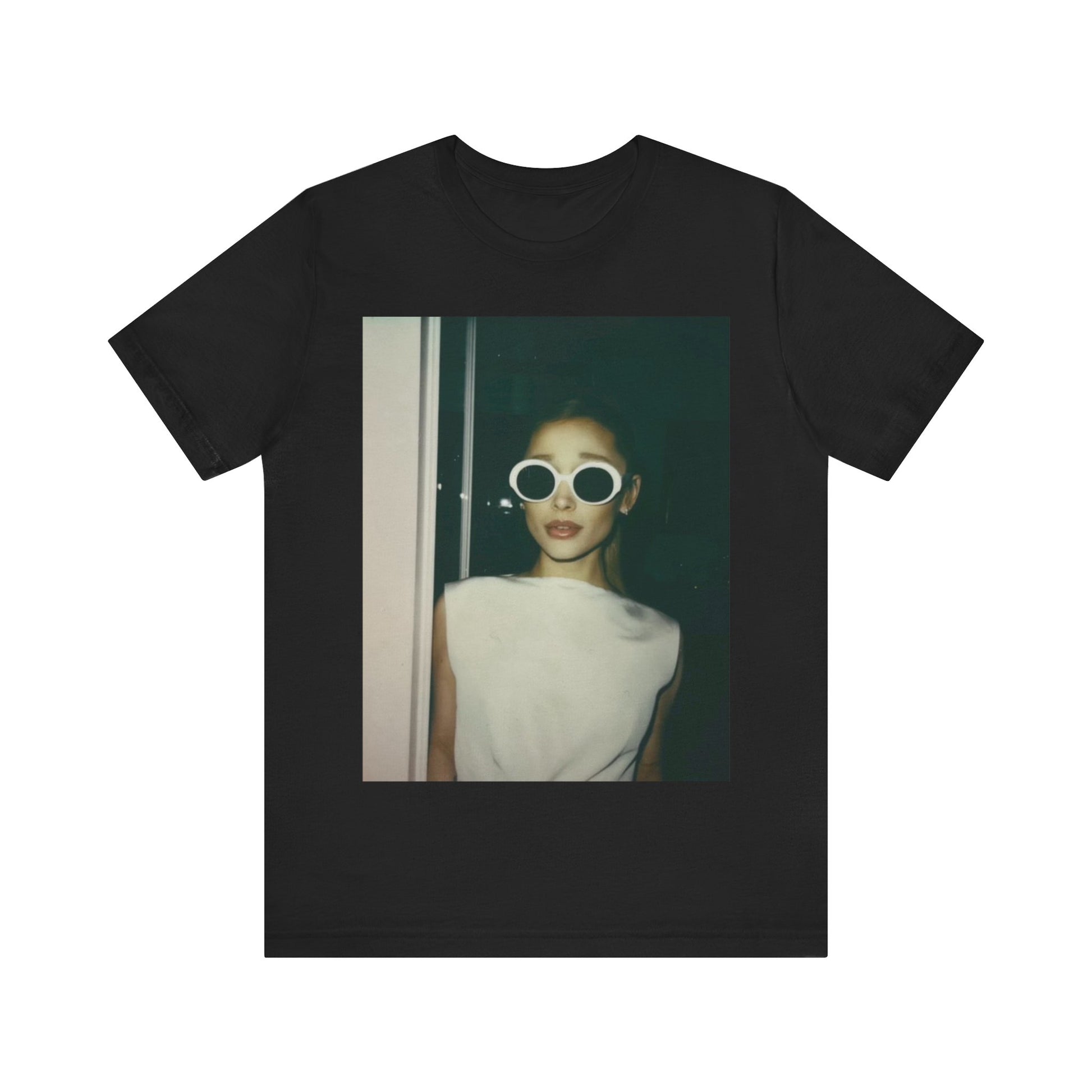 A black graphic t-shirt featuring a retro Polaroid-style photo of Ariana Grande.