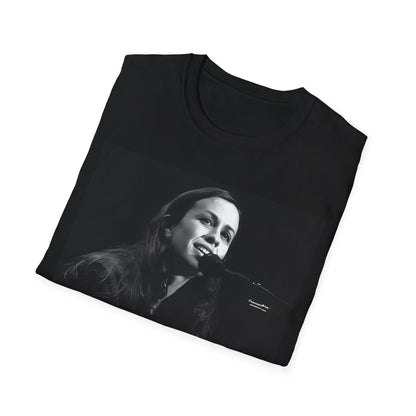 A black graphic t-shirt featuring a 90s-style graphic of Alanis Morissette on tour, possibly showing her performing or with tour elements.