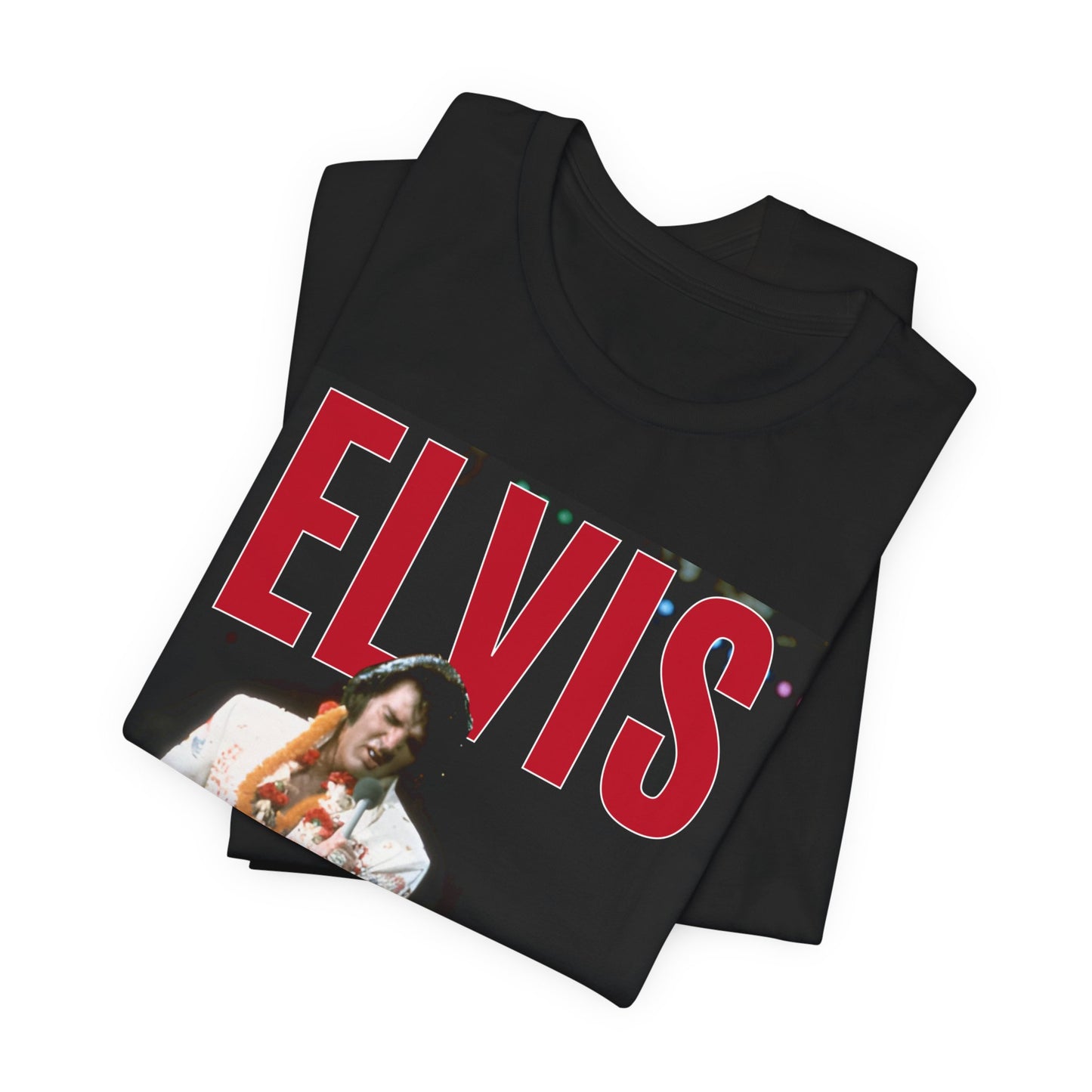 A black graphic t-shirt featuring a glamorous graphic or photo of Elvis Presley on a Las Vegas stage.