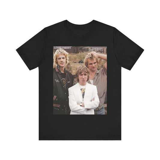A black graphic t-shirt featuring a graphic of The Police as a timeless three-piece band.
