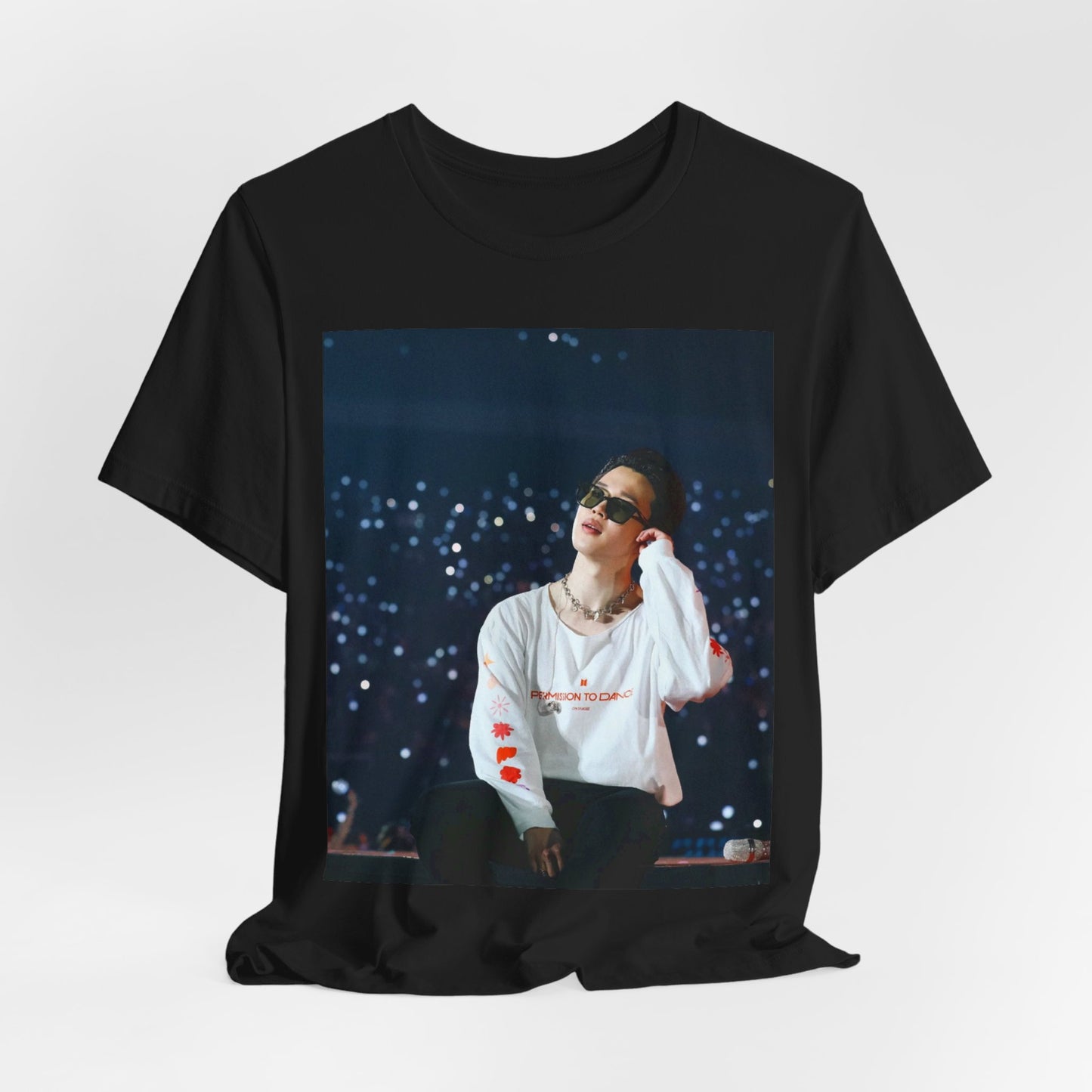 A black graphic t-shirt featuring a vintage aesthetic graphic related to Jimin's 'Lie' era.