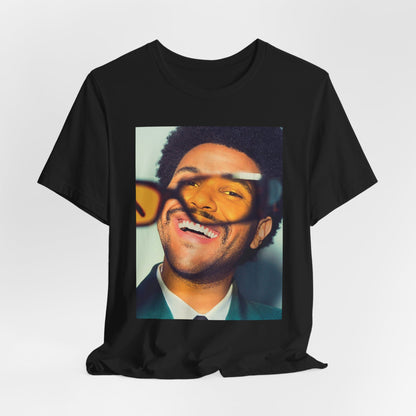 A black graphic t-shirt featuring a bold graphic of The Weeknd as a pop superstar.