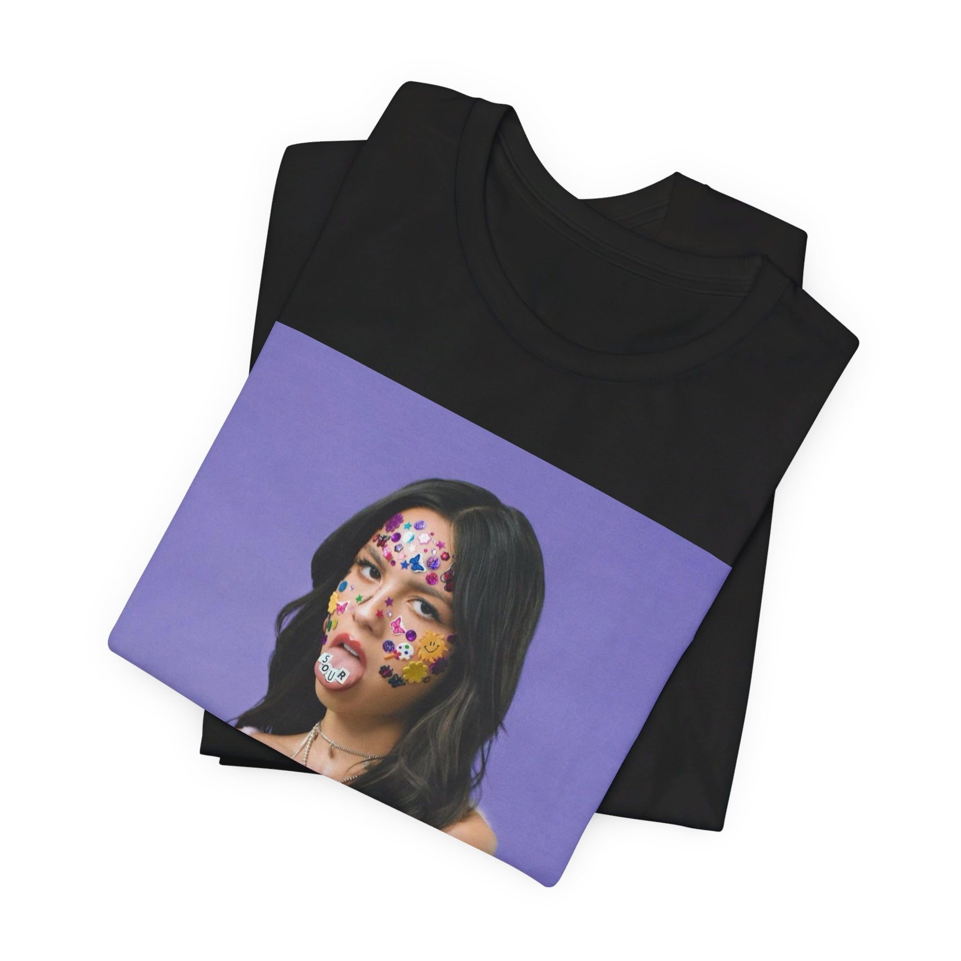 A black graphic t-shirt featuring a bold graphic of Olivia Rodrigo as a pop superstar.