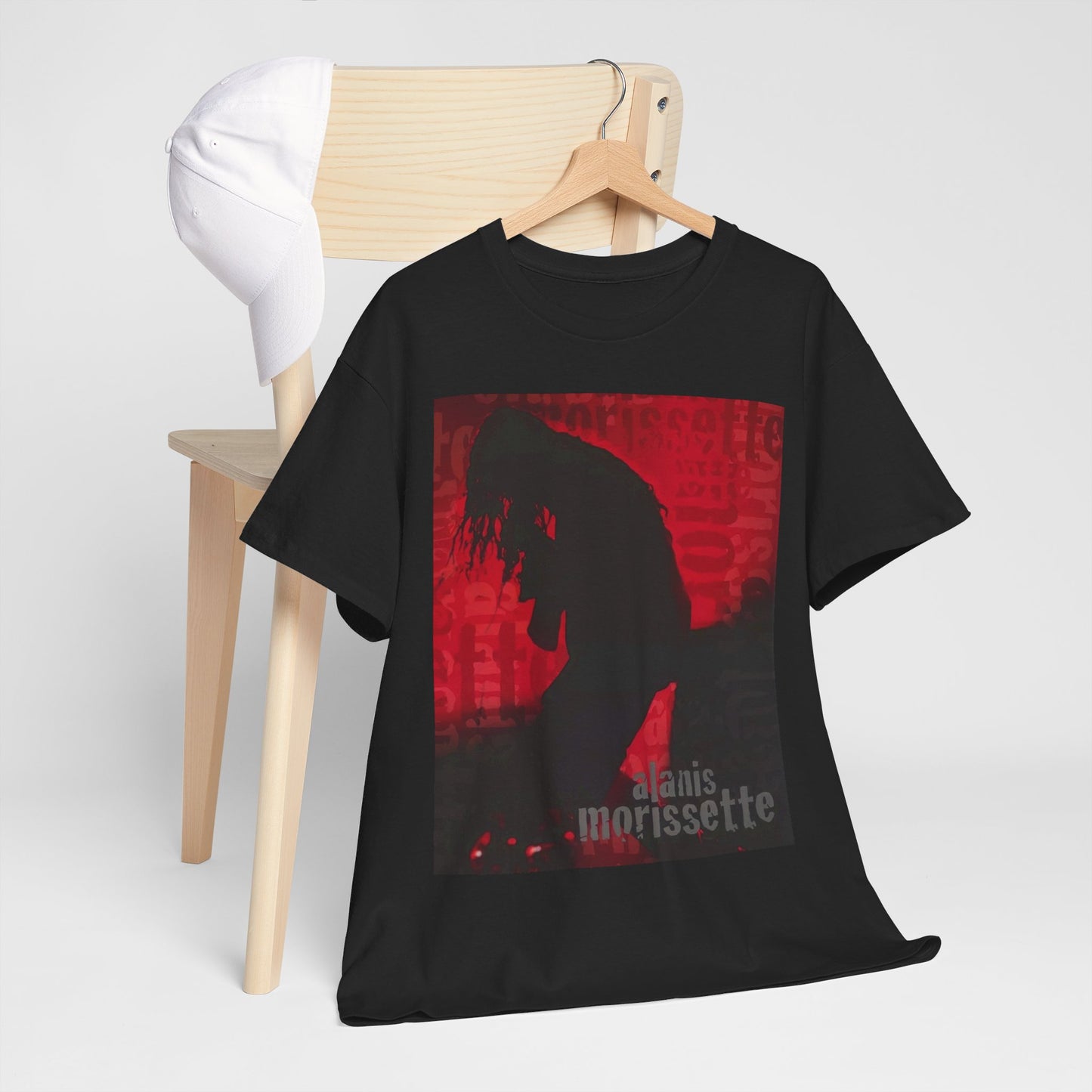 A black graphic t-shirt featuring a promotional graphic for an Alanis Morissette tour from the 2000s, possibly with stylized text and band imagery.