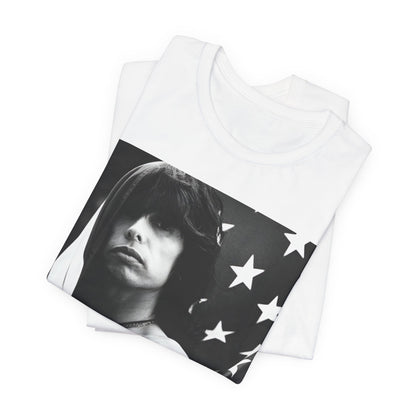 A black graphic t-shirt featuring a retro 70s-style illustration or photo of Aerosmith, integrated with elements of the American flag.