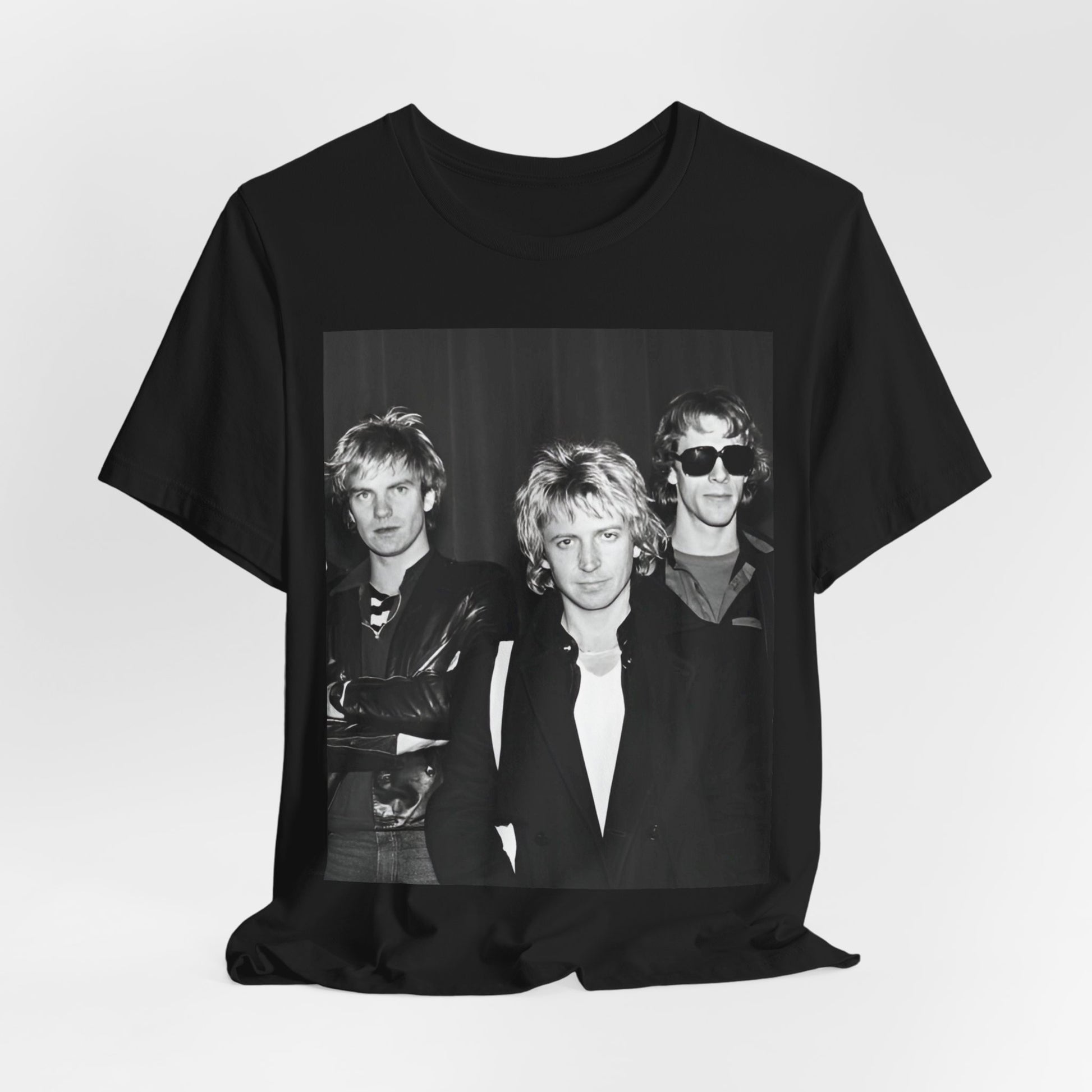 A black graphic t-shirt featuring a black and white, monochrome graphic or photo of The Police.