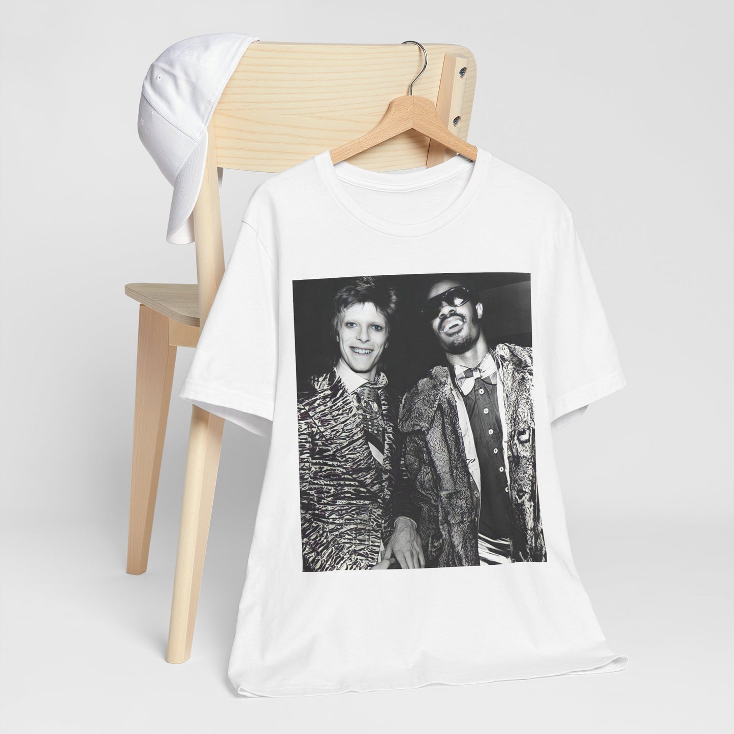 A black graphic t-shirt featuring a retro graphic of Stevie Wonder and David Bowie together.