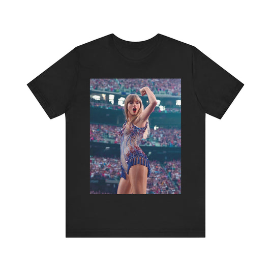 A black graphic t-shirt featuring a graphic or photo of Taylor Swift performing live on stage.