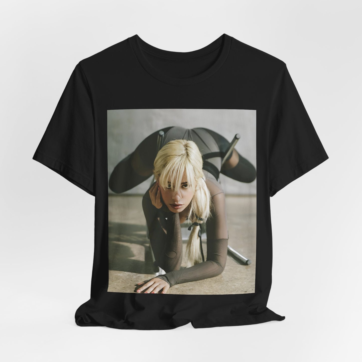 A black graphic t-shirt featuring a vintage-style graphic of Camila Cabello, possibly with a crown or 'Pop Queen' title.