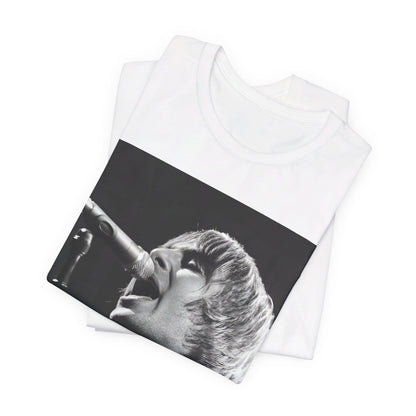 A black graphic t-shirt featuring a black and white graphic or photo of Liam Gallagher from Oasis performing live on stage.