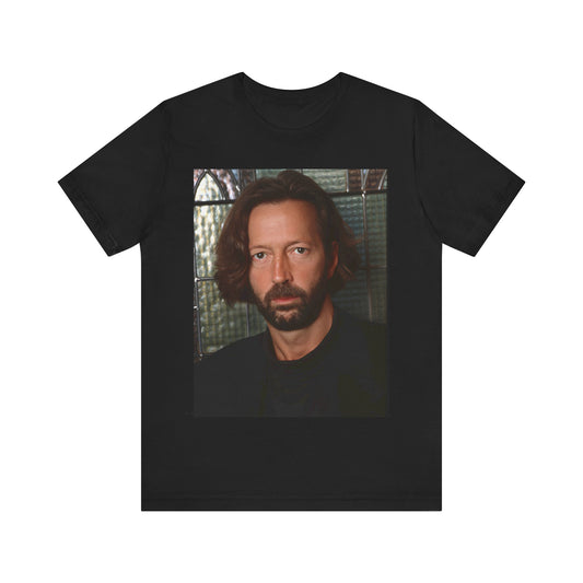 A black graphic t-shirt featuring a portrait graphic of Eric Clapton as a guitar god legend.