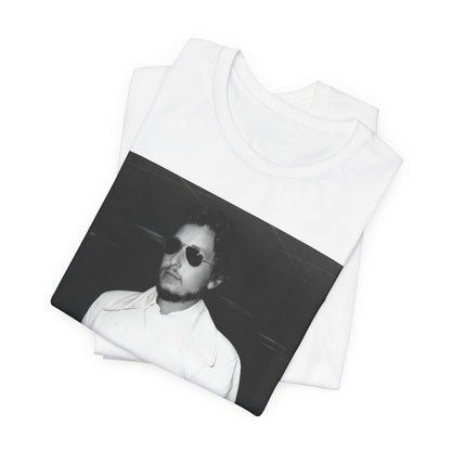 A black graphic t-shirt featuring a vintage black and white photo of Bob Dylan in a contemplative or iconic pose.