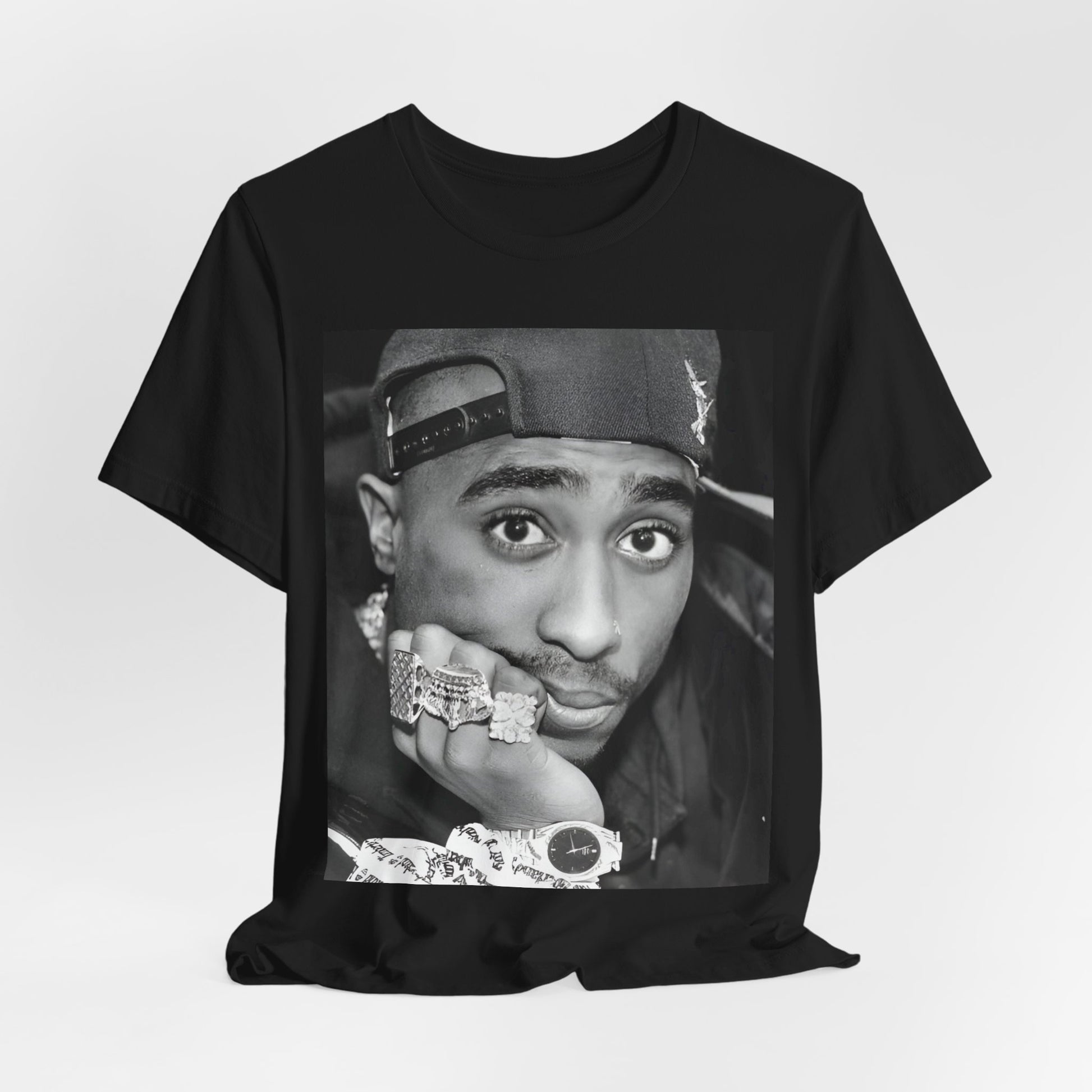 A black graphic t-shirt featuring a bold graphic of Tupac as a rap superstar.