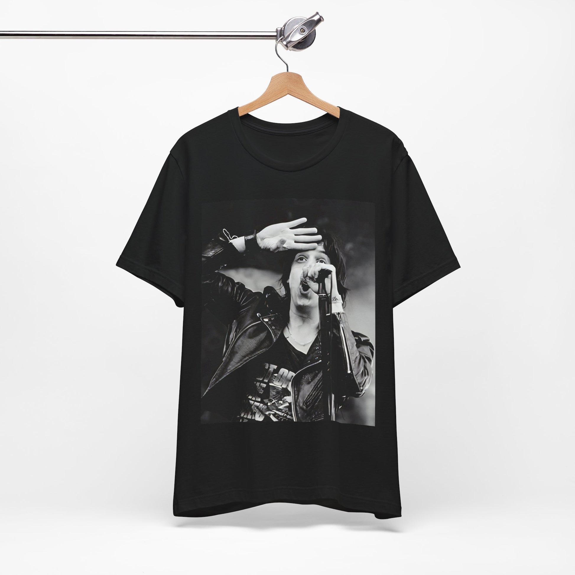 A black graphic t-shirt featuring a black and white portrait photo of The Strokes band.