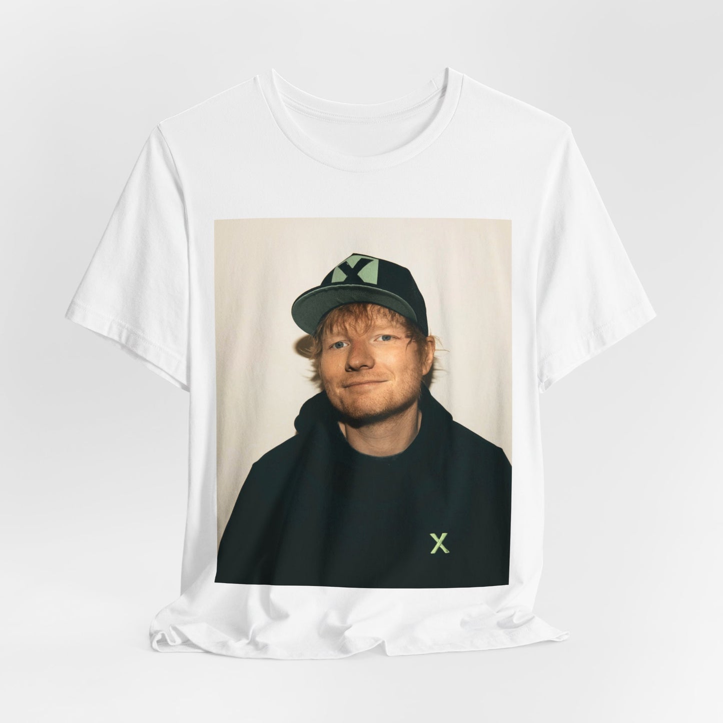 A black graphic t-shirt featuring a glamorous graphic of Ed Sheeran as a global tour icon.