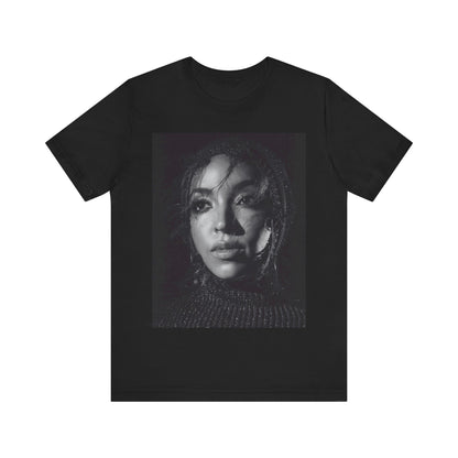 A black graphic t-shirt featuring a black and white portrait photo of Tinashe.