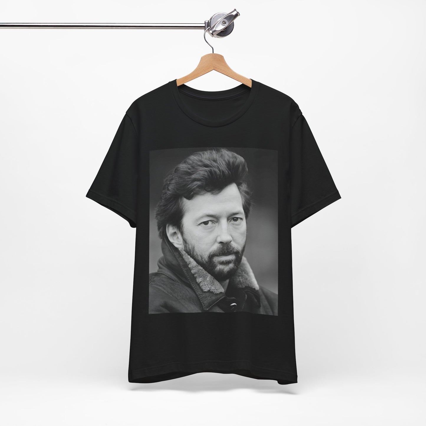 A black graphic t-shirt featuring a 70s rock aesthetic graphic of Eric Clapton.