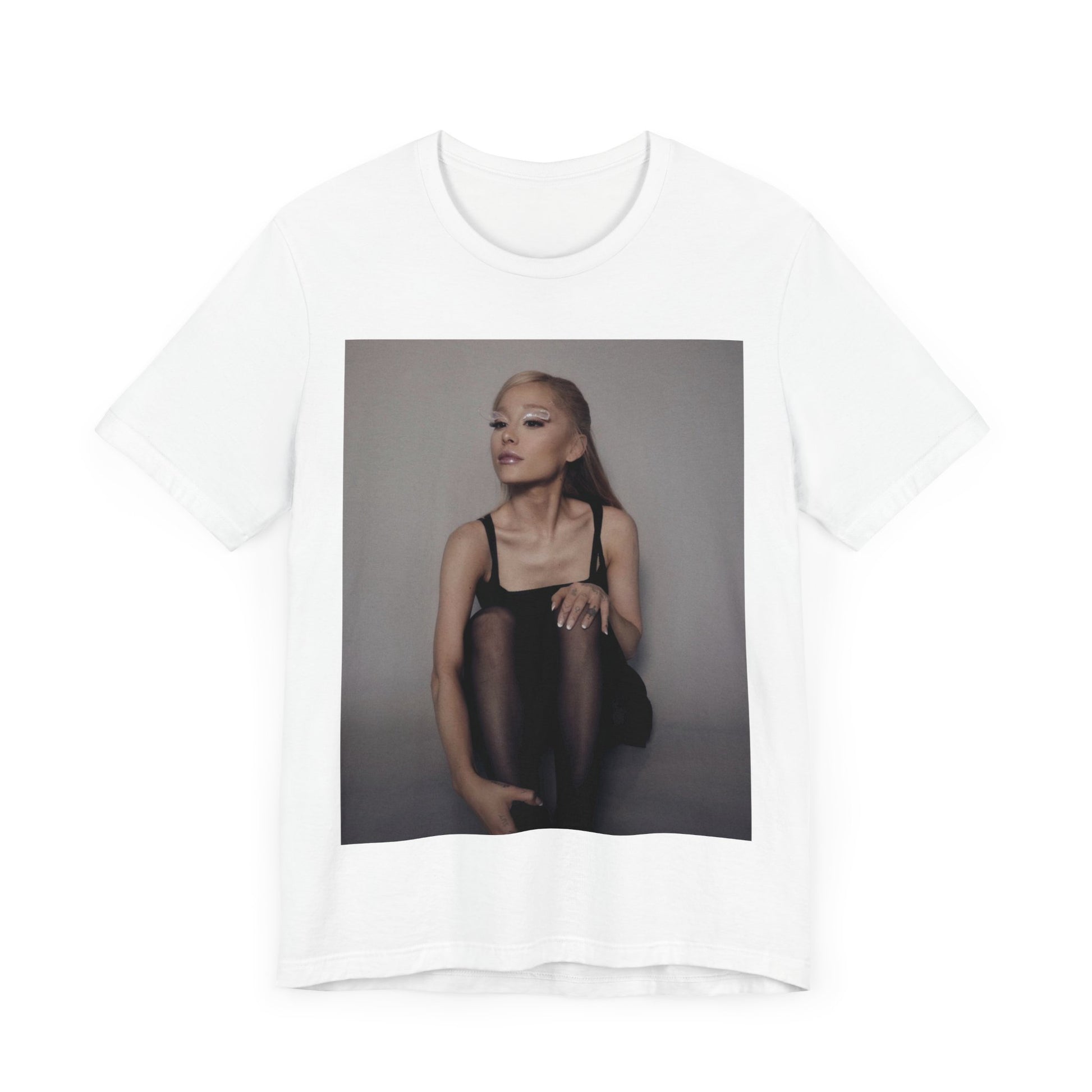 A black graphic t-shirt featuring a bold and beautiful graphic of Ariana Grande, emphasizing her strong and confident presence.