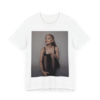 A black graphic t-shirt featuring a bold and beautiful graphic of Ariana Grande, emphasizing her strong and confident presence.