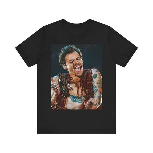 A black graphic t-shirt featuring a graphic or photo of Harry Styles performing live on stage.